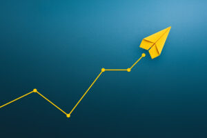 Yellow paper plane, volatility in the business and investment